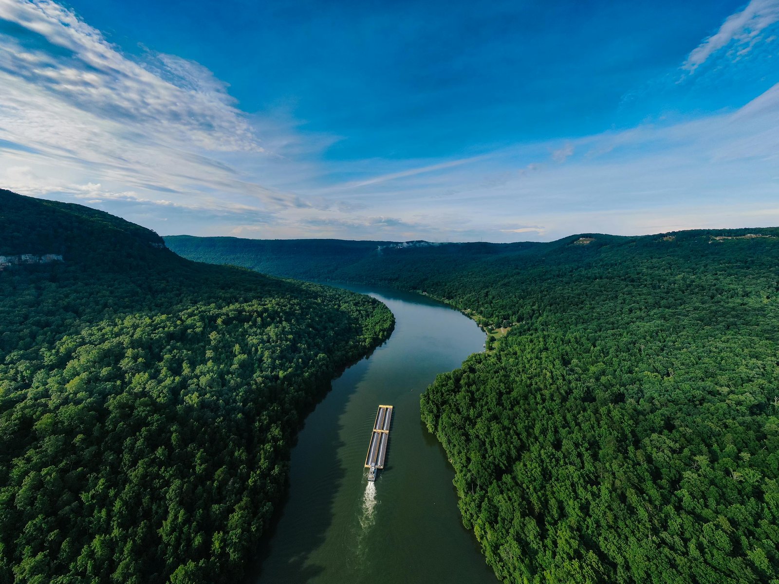 Photo from the air in the rainforest Aerial Photography of a Boat on a Waterway in the Middle of Forest